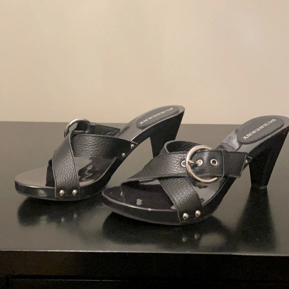Burberry Black cross strap heels w/ silver buckle.
